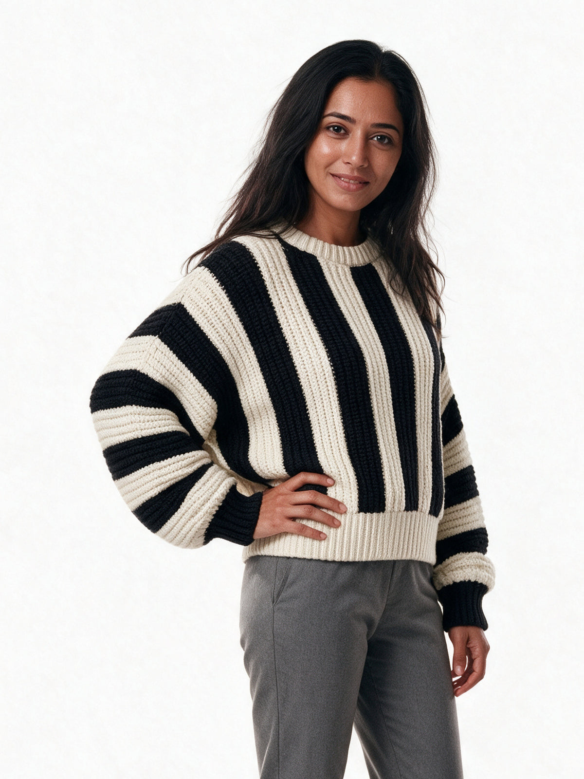 Amelia striped knit sweater seen from a three-quarter angle, showing the dropped shoulder and wide sleeve