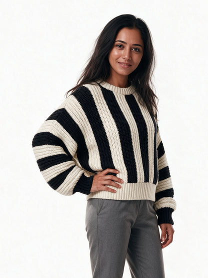 Amelia striped knit sweater seen from a three-quarter angle, showing the dropped shoulder and wide sleeve