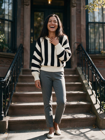 Amelia striped knit sweater worn on a brownstone stoop in autumn daylight