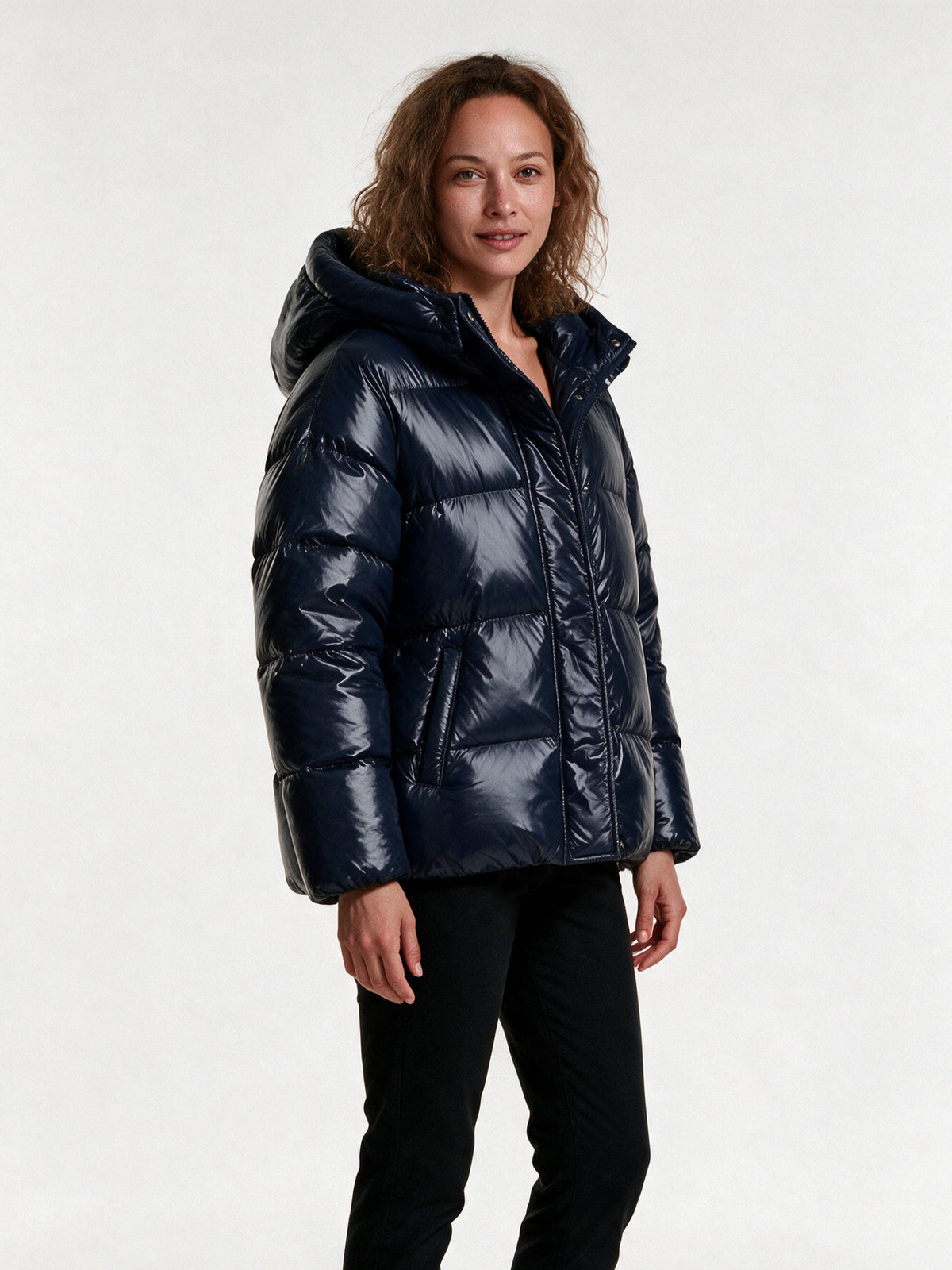 Livia navy puffer jacket from a three-quarter angle, showing the padded hood and quilted baffles