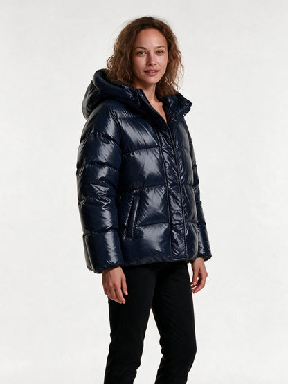 Livia navy puffer jacket from a three-quarter angle, showing the padded hood and quilted baffles