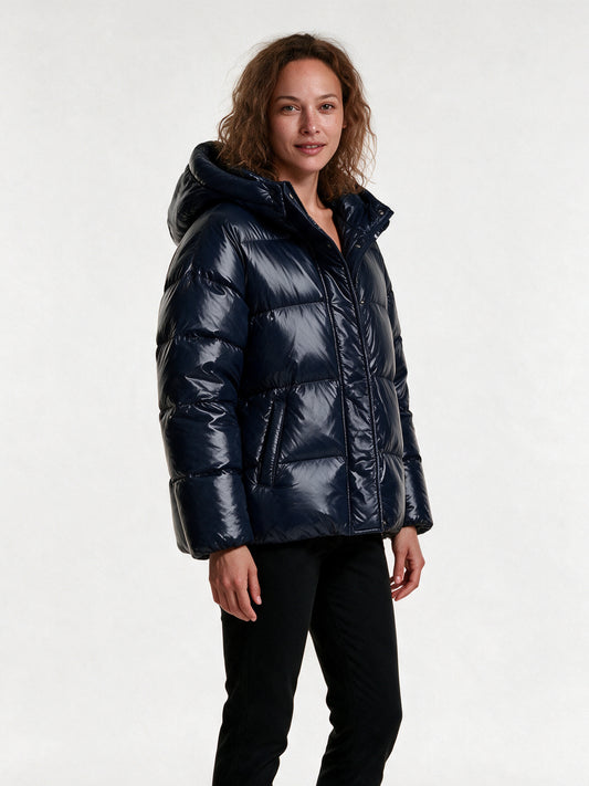 Livia navy puffer jacket from a three-quarter angle, showing the padded hood and quilted baffles