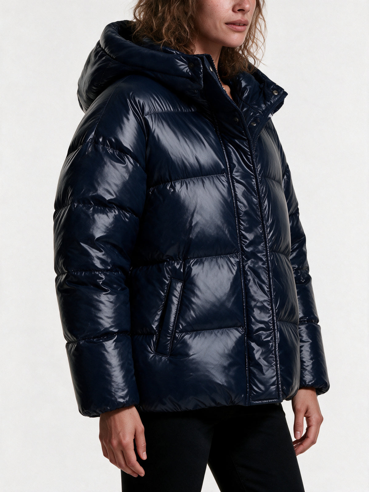 Close detail of the Livia puffer jacket, high-shine quilting, front zip and storm flap