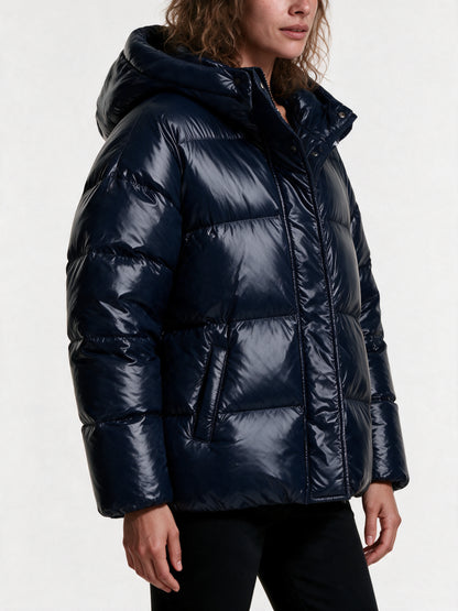 Close detail of the Livia puffer jacket, high-shine quilting, front zip and storm flap