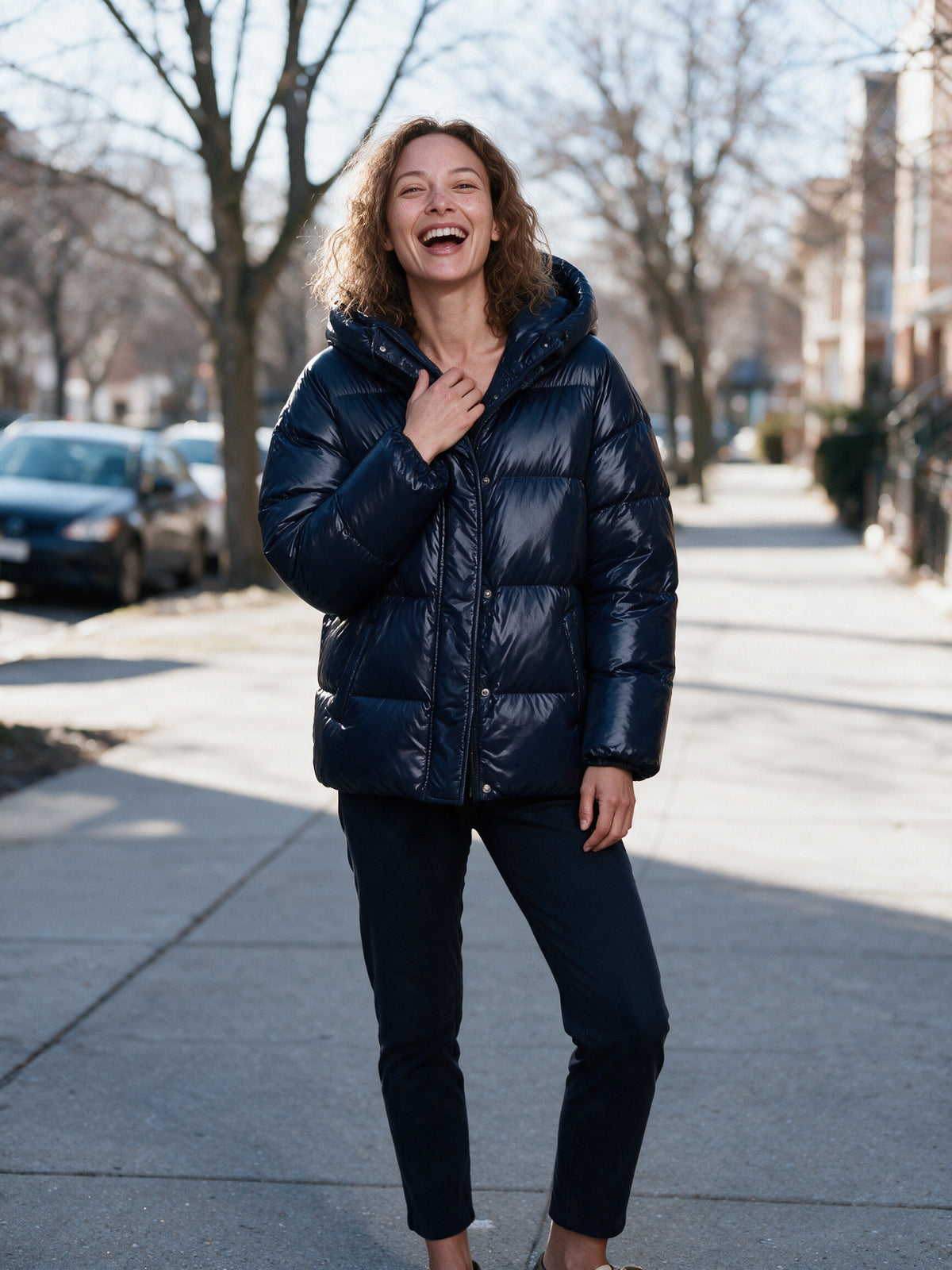Livia navy puffer jacket worn on a winter sidewalk