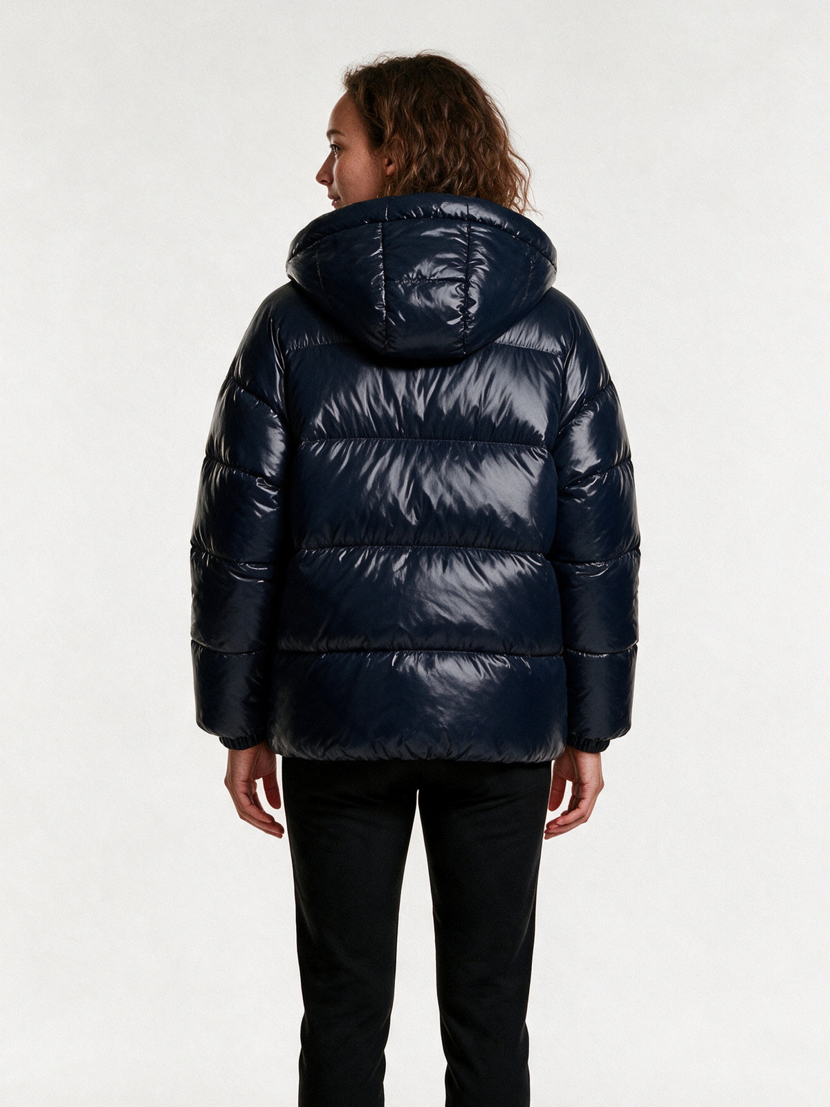 Back view of the Livia navy puffer jacket showing the hood and horizontal baffles