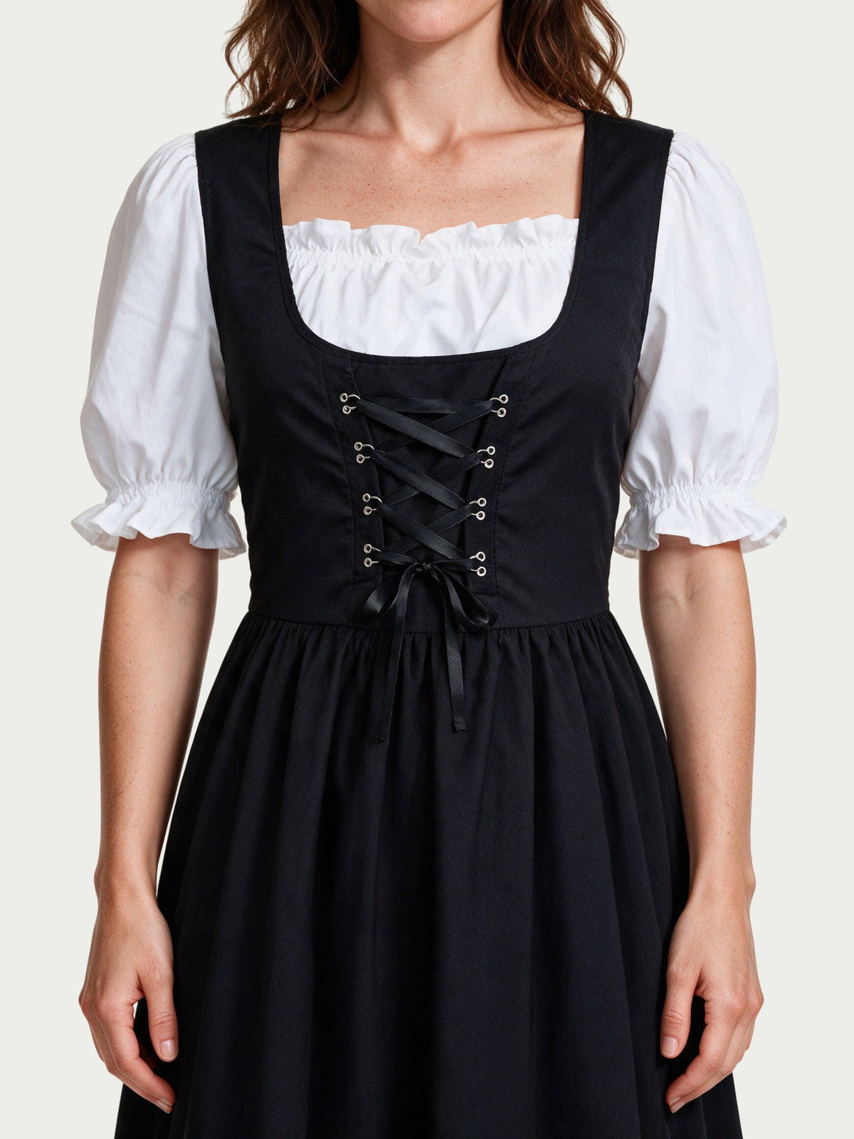 Close detail of the square neckline, silver eyelets and black ribbon lacing on the Lorelei dress