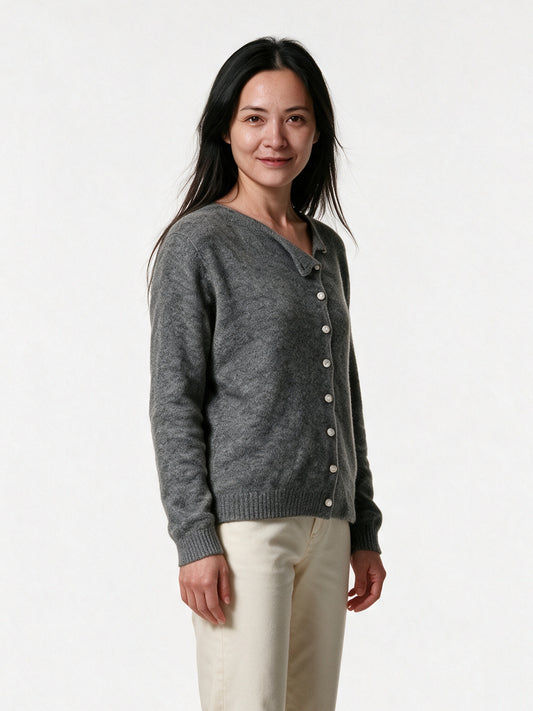 Perla grey cardigan from a three-quarter angle, showing the diagonal button placket
