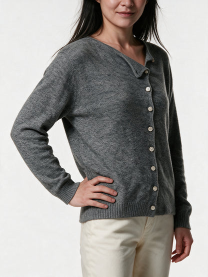 Close detail of the Perla cardigan, fine knit and the row of small pale buttons