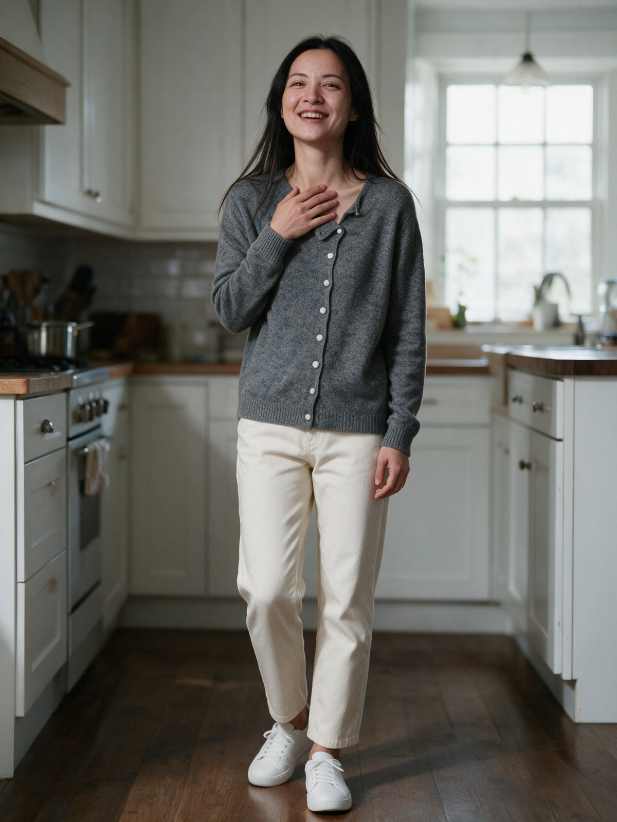Perla grey cardigan worn in a bright kitchen in morning light