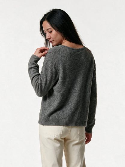 Back view of the Perla cardigan showing the plain knit back and ribbed hem