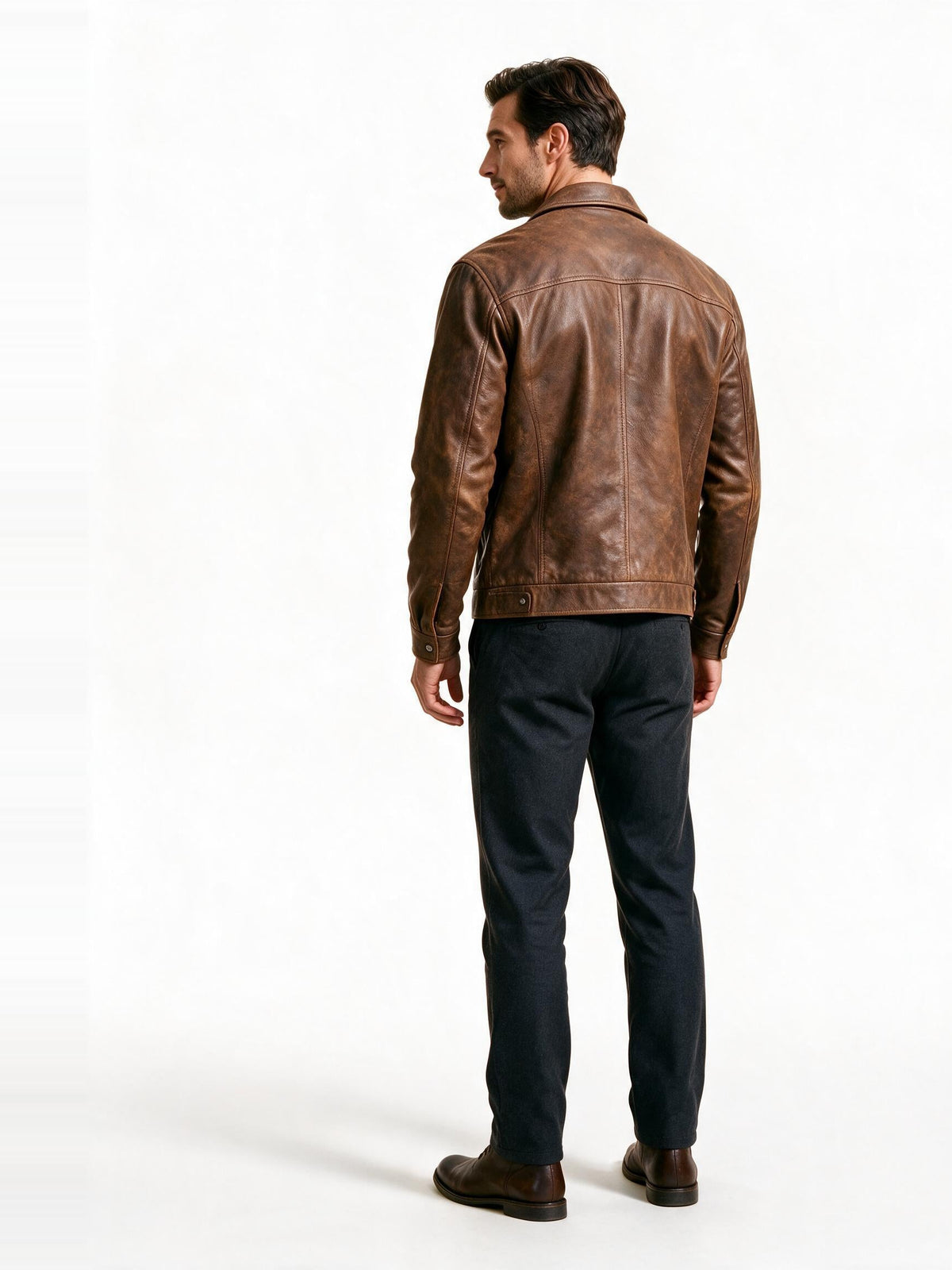 Back view of the brown leather trucker jacket showing the yoke, sleeve set and waistband