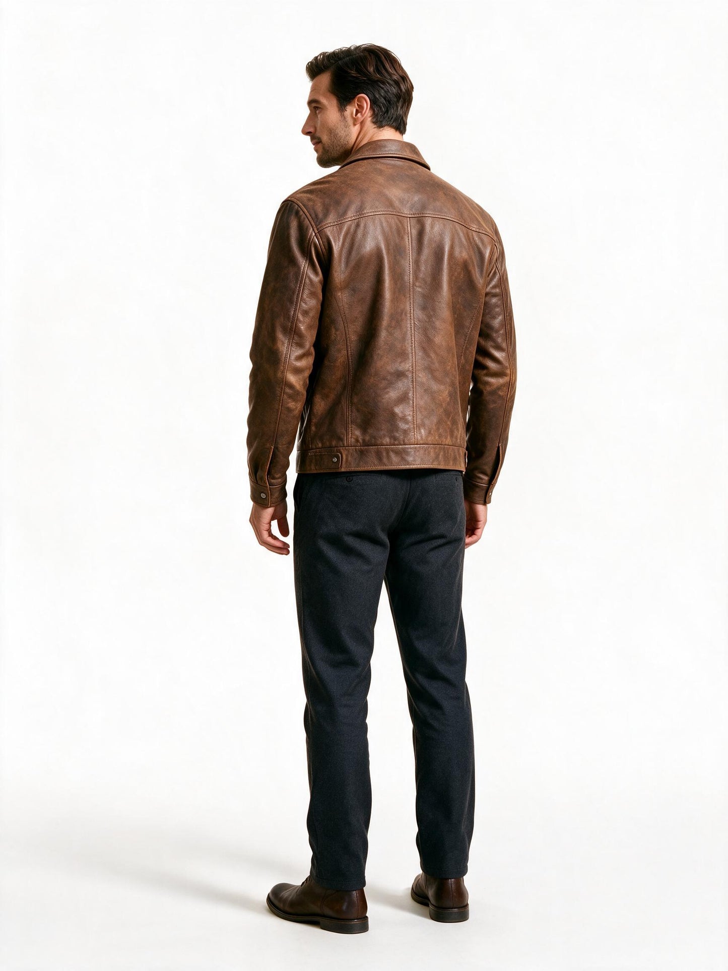 Back view of the brown leather trucker jacket showing the yoke, sleeve set and waistband