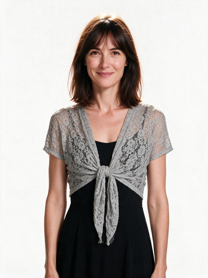 Grey lace tie-front bolero shrug worn over a black dress, studio white