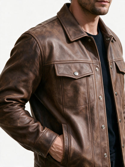 Close-up of the leather jacket's spread collar, silver snap placket and flap chest pocket