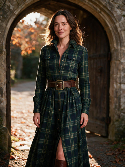 Woman wearing the green Marlowe tartan maxi dress in a stone manor doorway in autumn