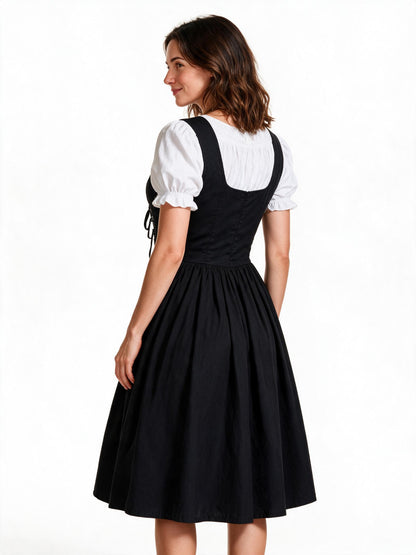 Black lace up maid dress, back view showing bodice seams and full skirt