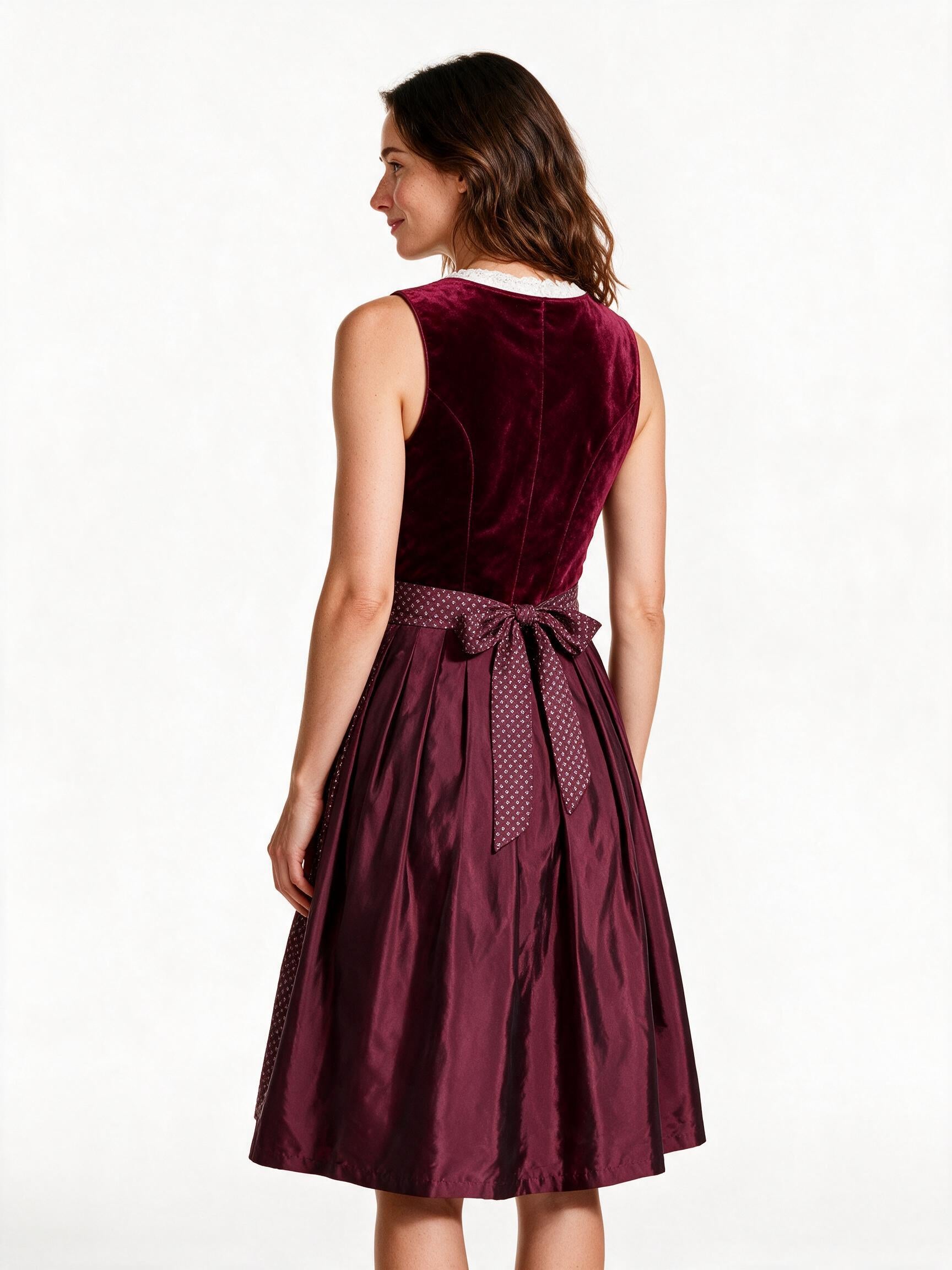 Burgundy velvet dirndl dress, back view showing apron ties and skirt