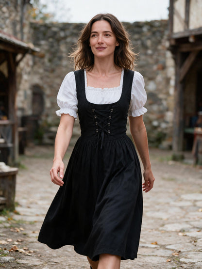 Woman walking a stone courtyard at a renaissance fair in the black lace up dress
