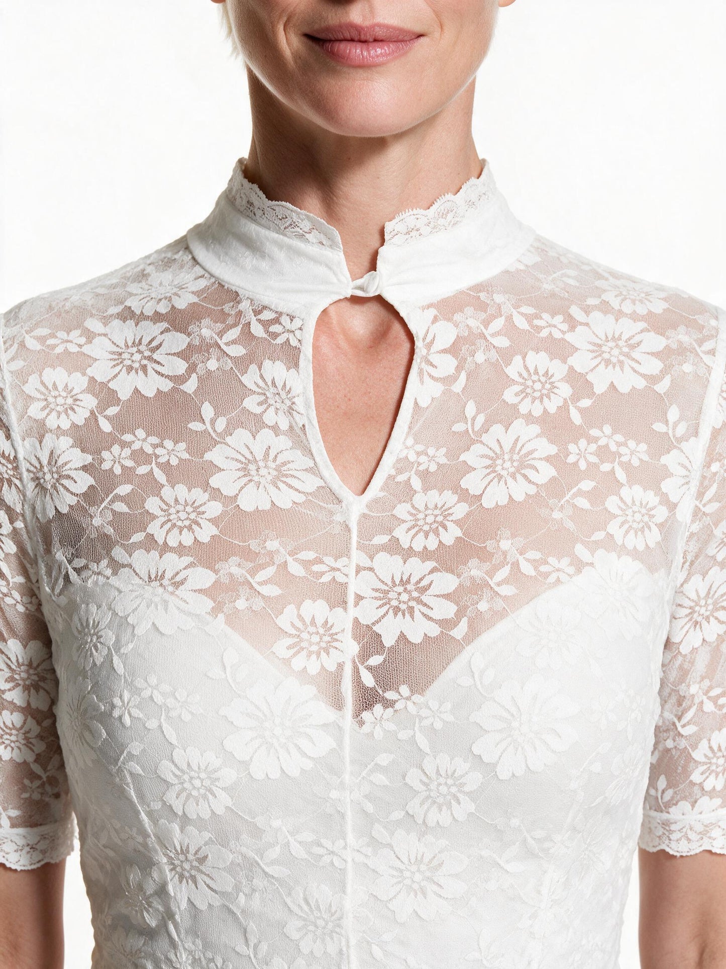 Close detail of the lace stand collar and keyhole opening