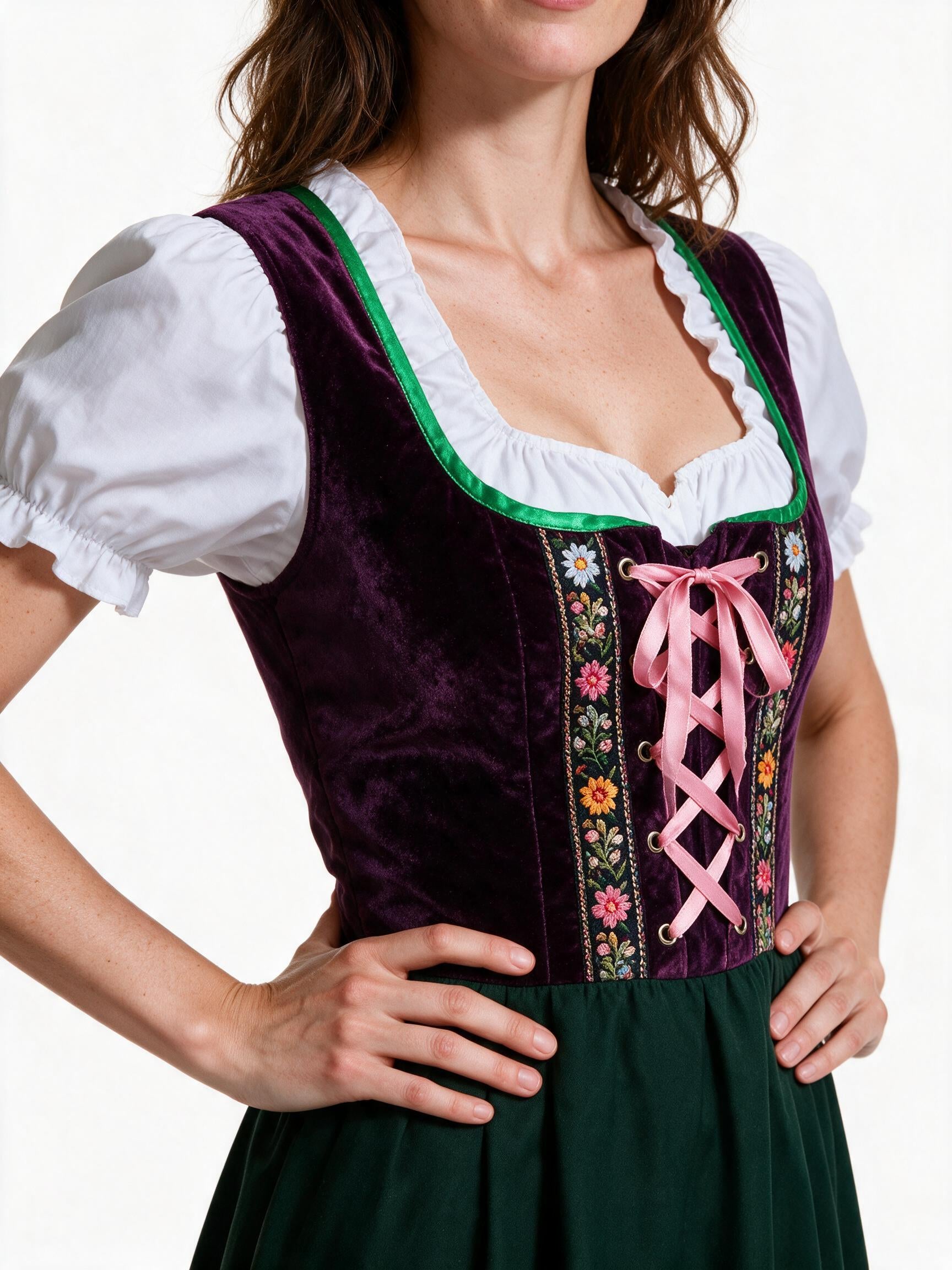 Close detail of the embroidered folk braid and pink ribbon lacing